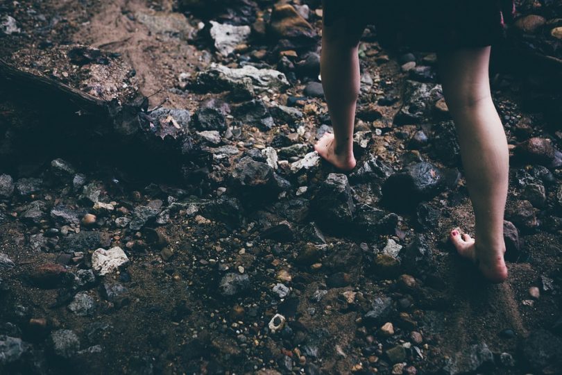 picture of a woman hiking barefoot