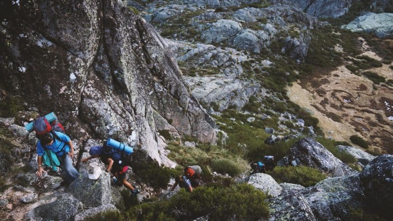 a group of people climbing the mountain
