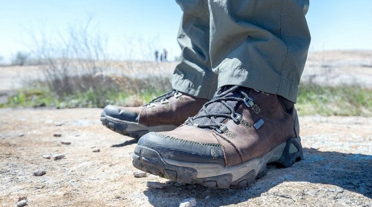 Close up photo of a man's legs wearing hiking boots