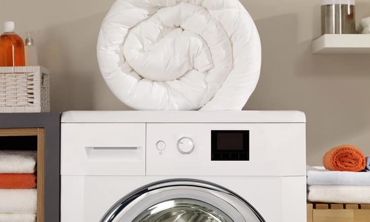 A pillow on top of a washing machine