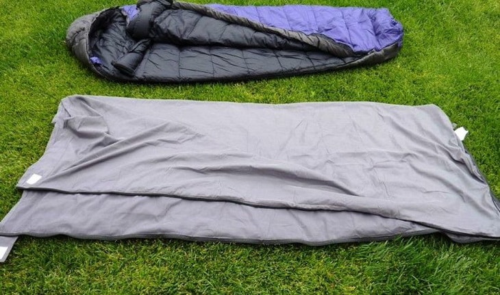 Two Sleeping Bag Liners on the grass