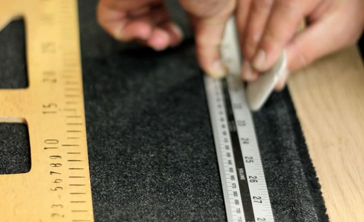 A person measuring some material