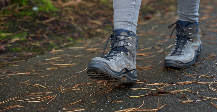 a hiker walking in their boots in an urban environment