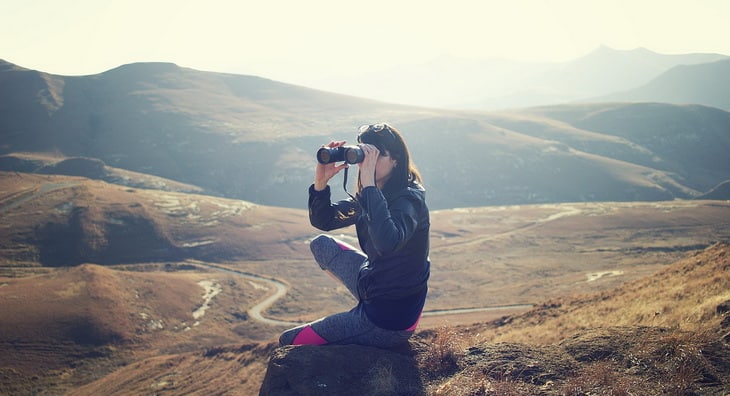 woman watching the landscape with a binocular