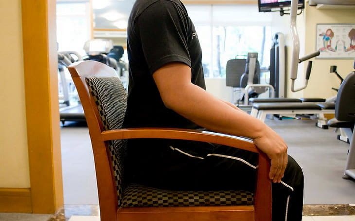 man showing a chair exercise