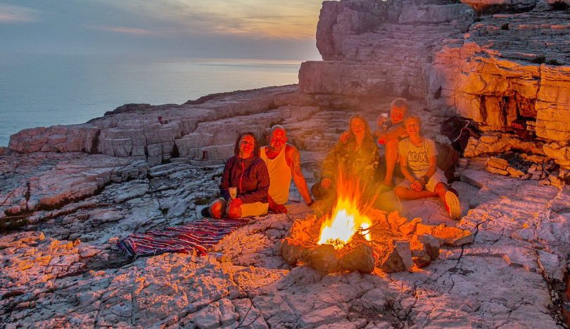 group of people around a campfire