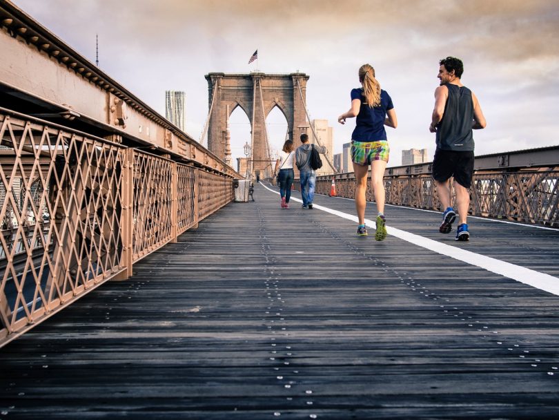 picture of two runners on a bridge