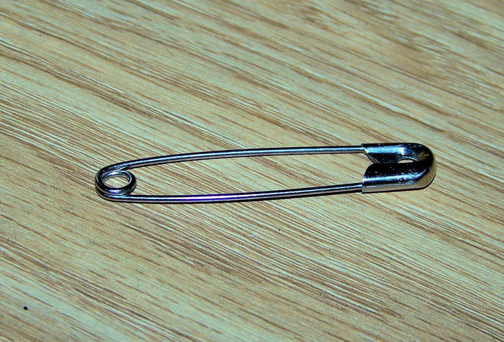 clouse-up photo of a safety pin on the table 