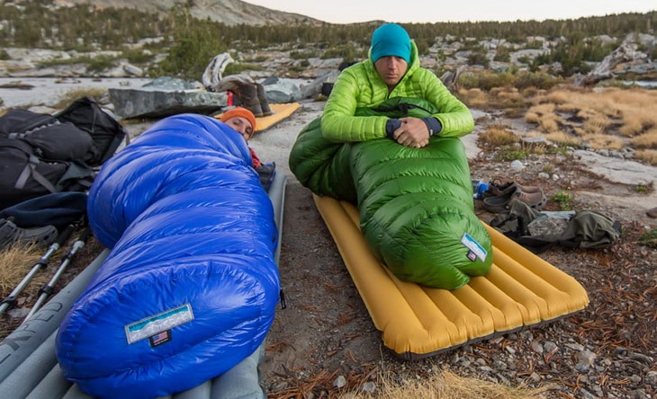 Two adults in Western Mountaineering Puma Gore WS Sleeping Bags in the wilderness
