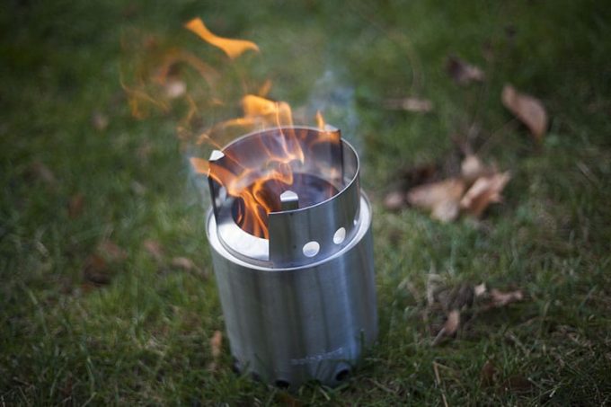 solo stove burning on grass