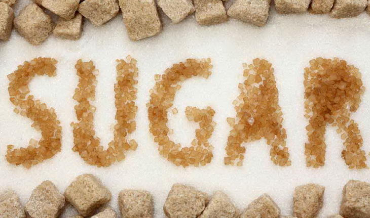 Sugar word written with sugar on a table
