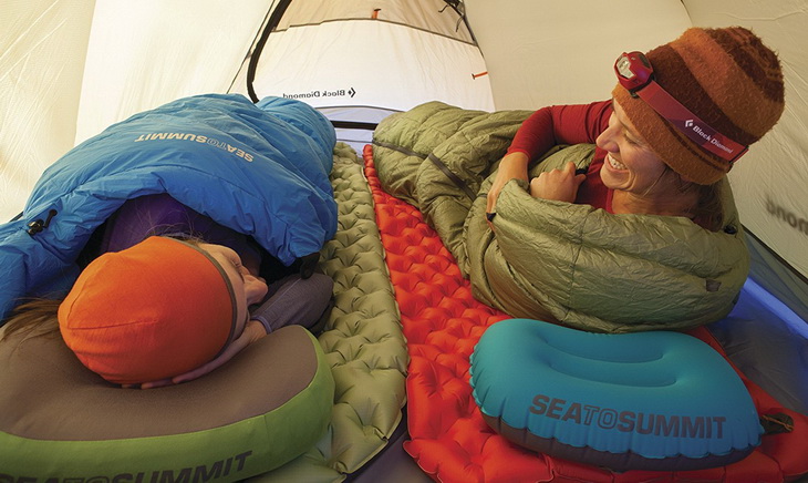 Two womens sitting in a tent on Sea to Summit Ultralight Mats