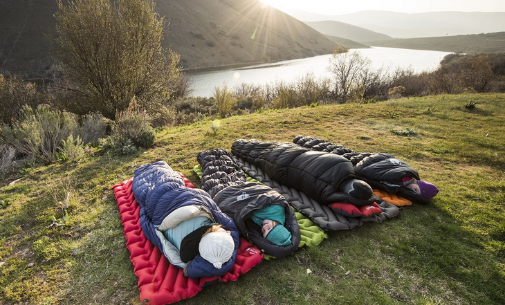 Four aduls in sleeping bags in the morning