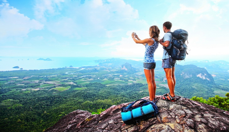 Backpackers on top of the mountains taking a selfie