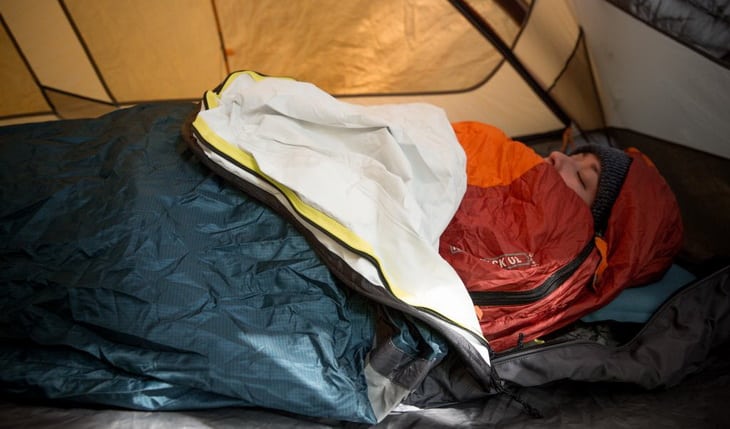 Woman sleeping in a tent with her face up