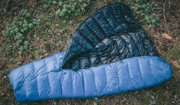 Blue sleeping bag on the ground
