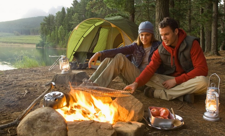 Couple camping near a lake