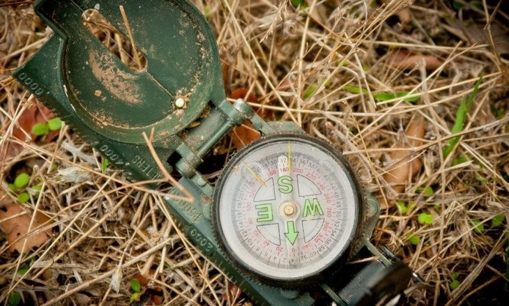 Dirty green compass on the ground