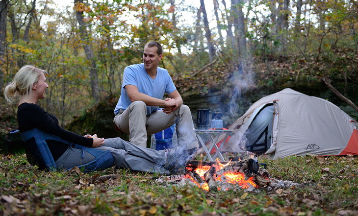 Two adults camping in the forest