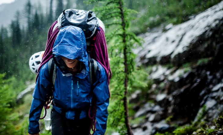 Woman hiking in the forest on a rainy day