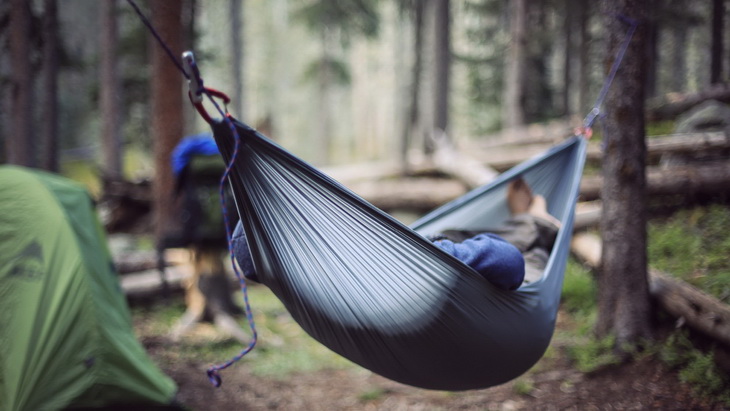 A person relaxing in the Grand Trunk Nano Hammock