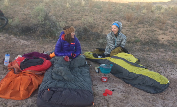 Two womens in sleeping bags outside