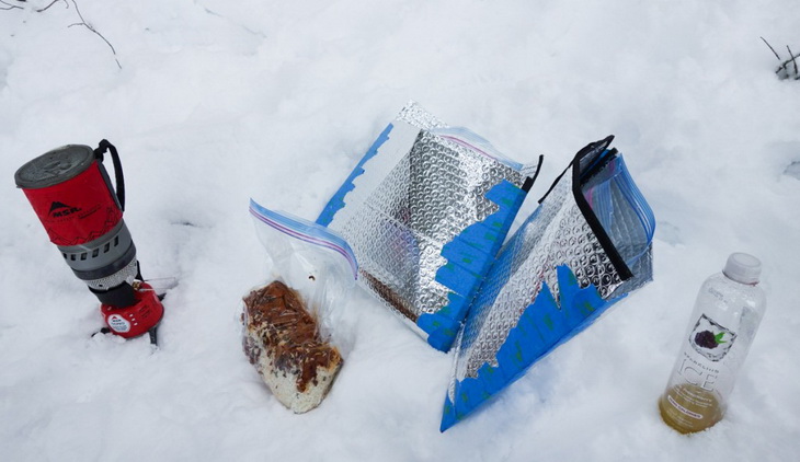 insulated pouches and some food on the snow