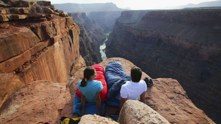 People sleeping on the edge of a cliff