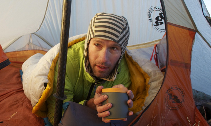 Man relaxing in Sea to Summit Spark II Sleeping Bag driking a cup of coffee