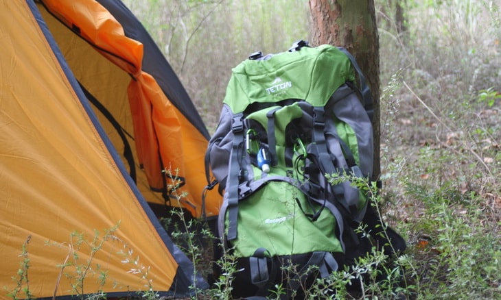 Teton Sports Escape 4300 Ultralight Internal Frame Backpack near a tent