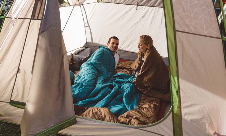 A couple italking to each other in the tent 