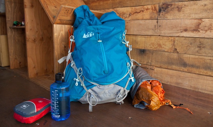 REI backpack laying on the ground