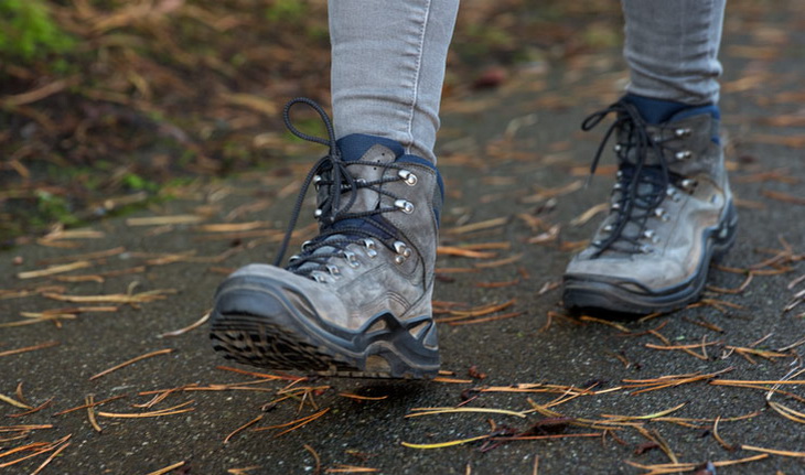 a hiker walking in their boots in an urban environment