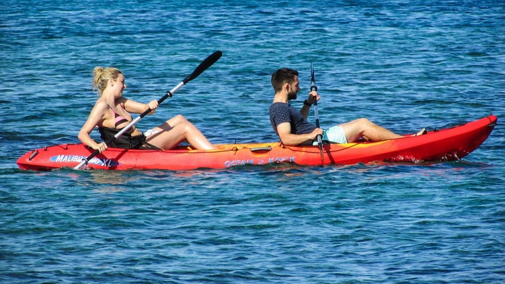 Young couple having fun paddling