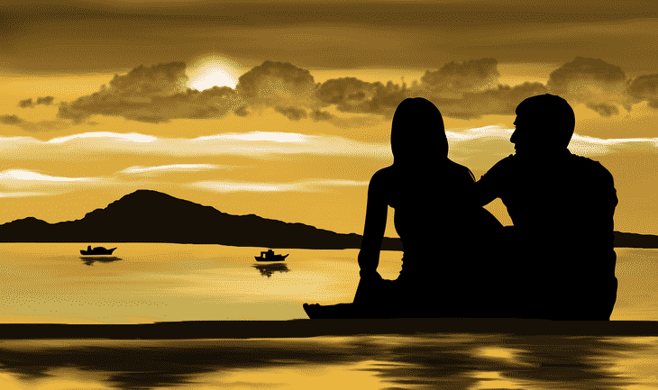 a couple on a beach at sunset