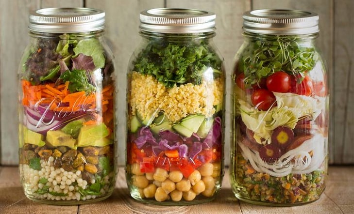healthy salad in jars on the table