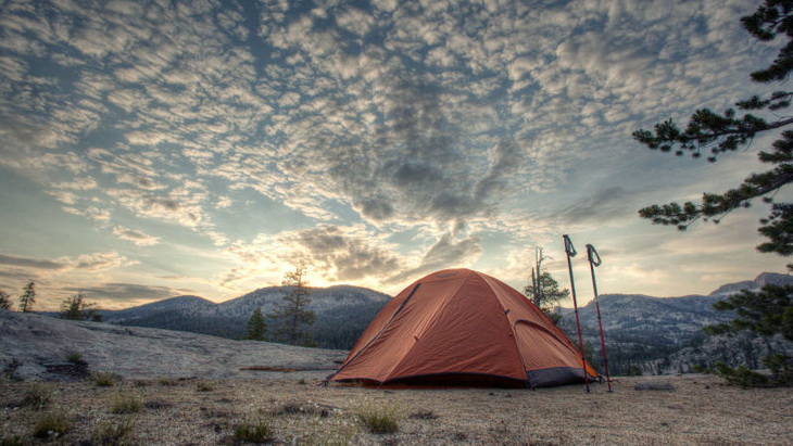 a tent and a beautiful sunset