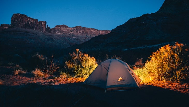 A tent outside in the nature during night time