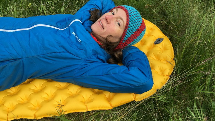 A woman testing Sea to Summit Ultralight Mat