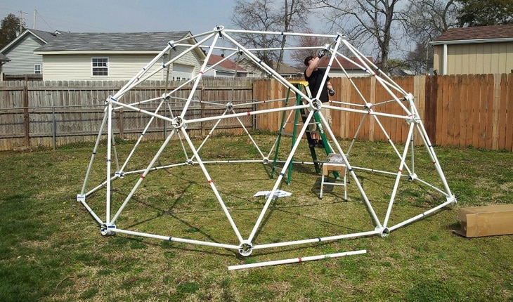 Man working on a homemade dome tent