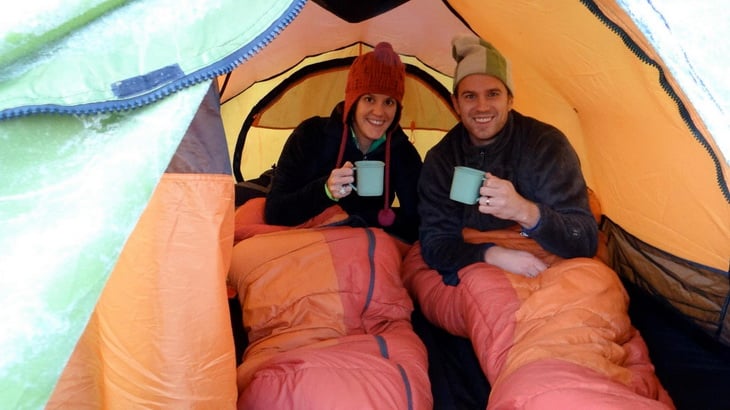 Young couple taking a picture in a tent