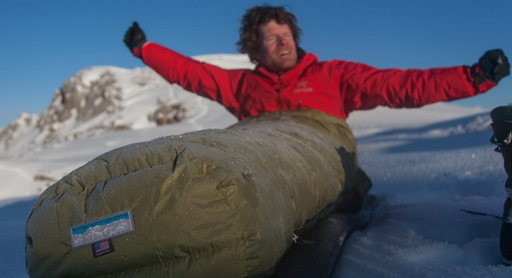 Man in the morning in a Western Mountaineering Cypress sleeping bag 