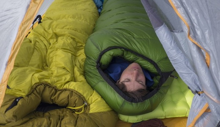 Man in a Western Mountaineering Kodiak sleeping bag