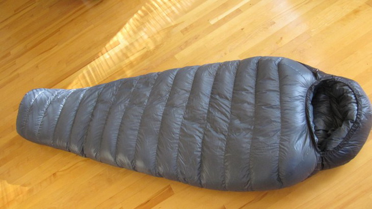 Western Mountaineering Kodiak sleeping bag laying on the floor in the house