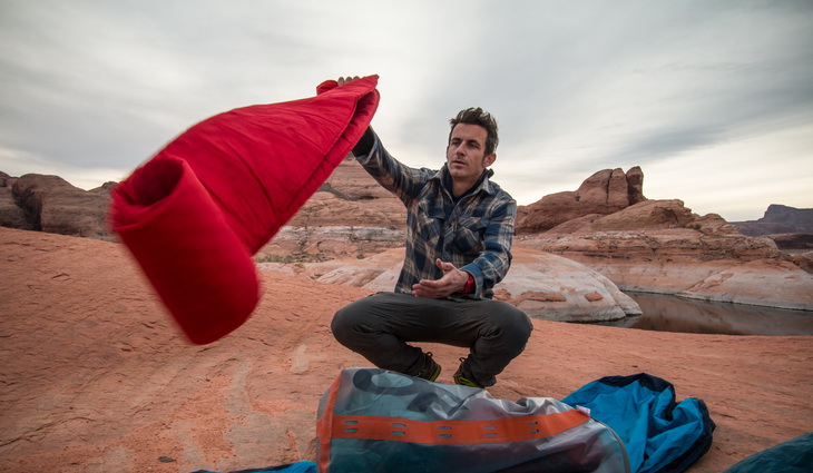 A man holding Therm-a-Rest ProLite Mattress and a landscsape in the backgroun