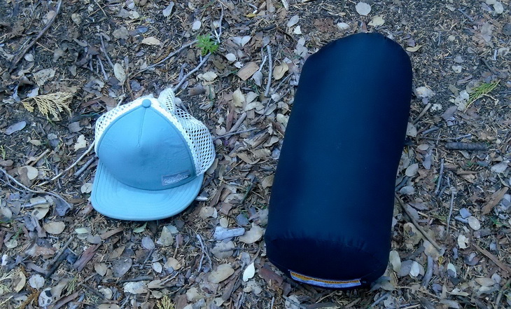 Western Mountaineering Ultralite Mummy Sleeping Bag and a hat on the ground