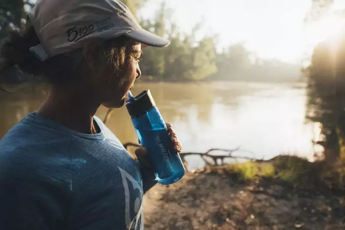 hiker drinking water from lifestraw