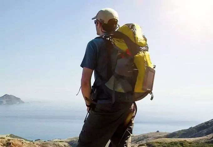hiker wearing solar charger on backpack