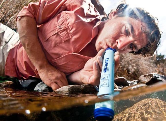 hiker drinking water with lifestraw