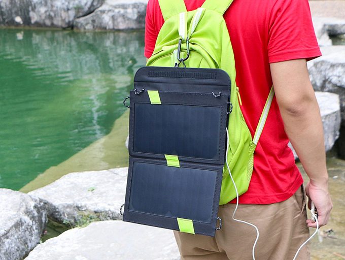 hiker charging his phone while walking